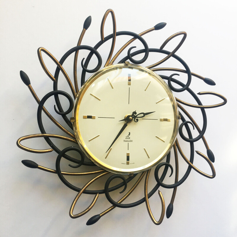 Vintage swiss Sunburst clock in iron and brass 1960