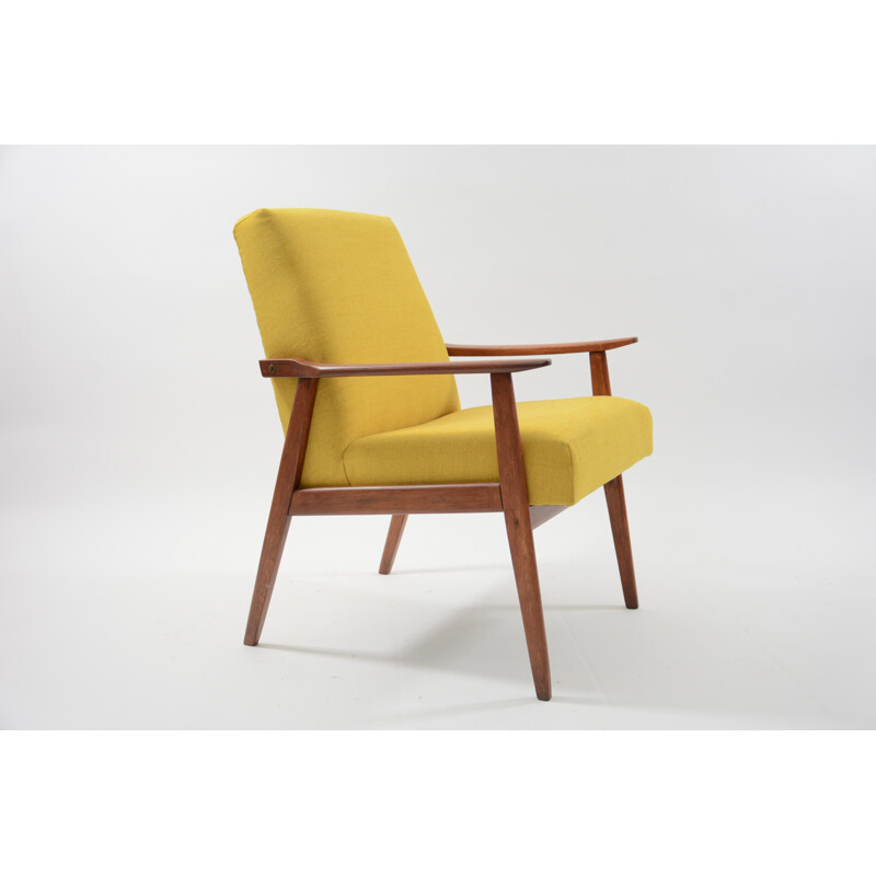 Vintage armchair made of yellow fabric