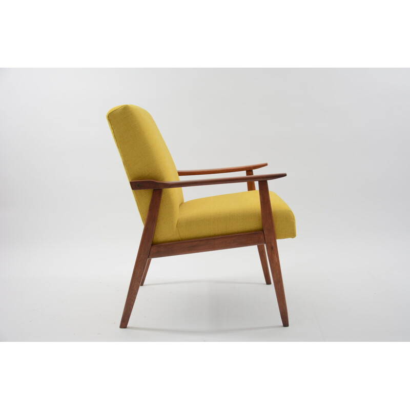 Vintage armchair made of yellow fabric