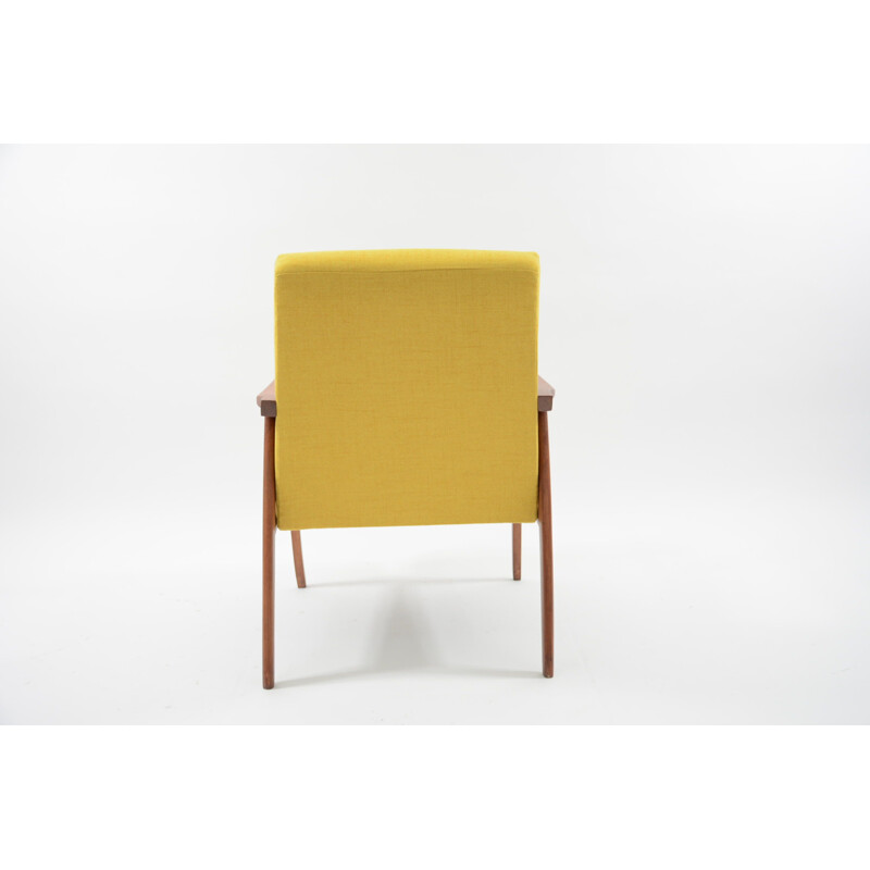 Vintage armchair made of yellow fabric