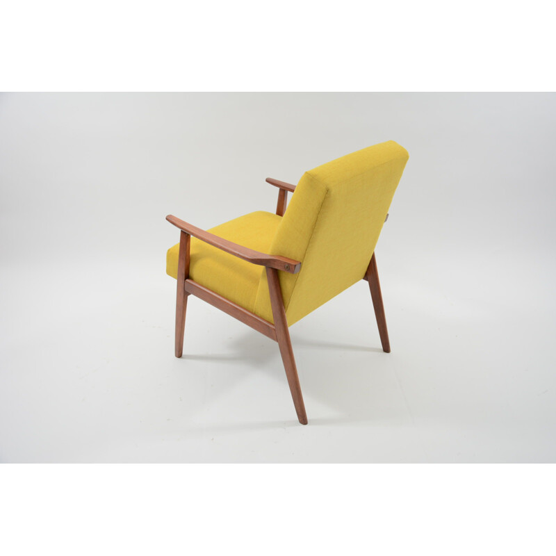 Vintage armchair made of yellow fabric