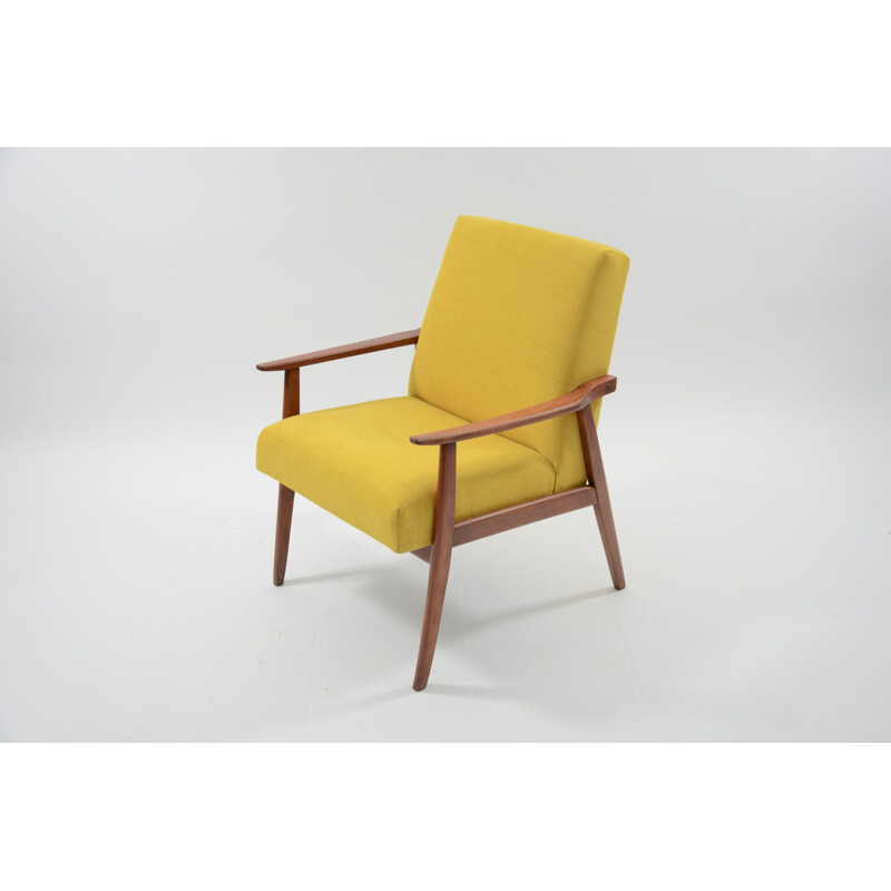 Vintage armchair made of yellow fabric