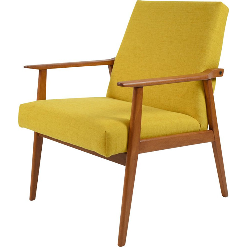 Vintage armchair made of yellow fabric