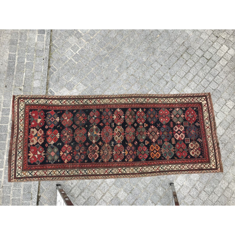 Vintage caucasian rug in wool with geometric patterns