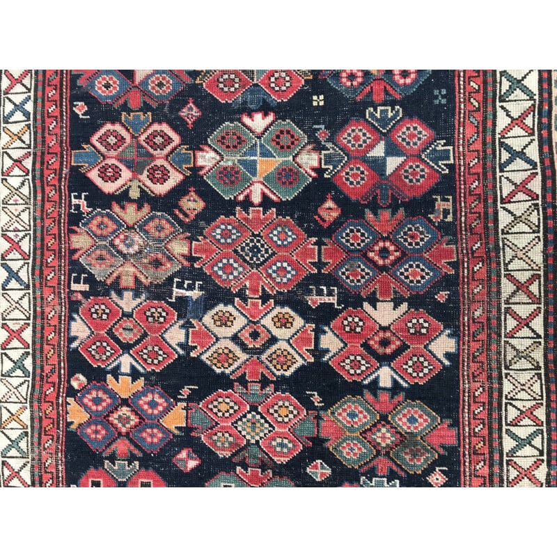 Vintage caucasian rug in wool with geometric patterns