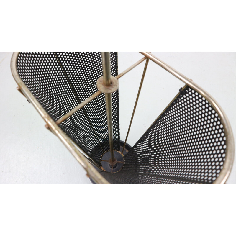 Vintage umbrella stand in perforated metal