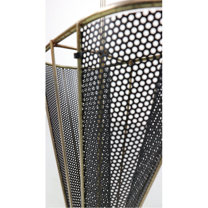 Vintage umbrella stand in perforated metal