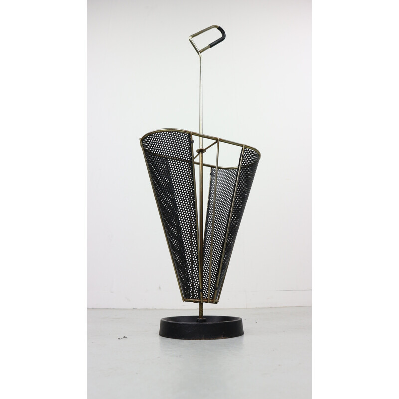 Vintage umbrella stand in perforated metal