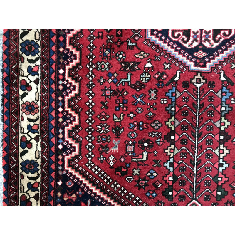 Red Persian carpet in wool