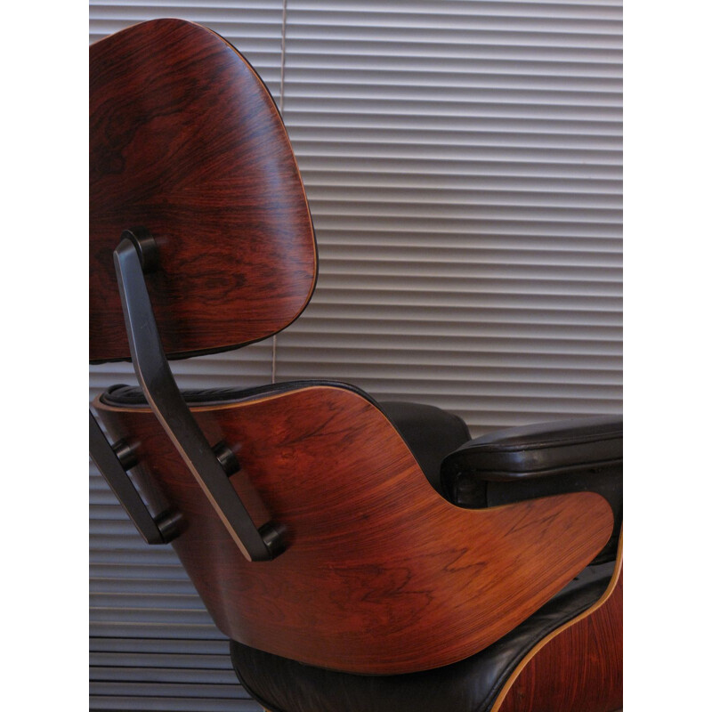 Vintage armchair in black leather and rosewood by Eames