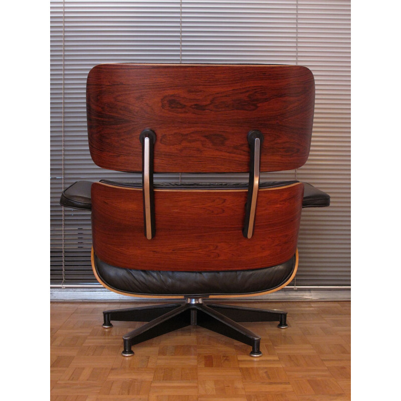 Vintage armchair in black leather and rosewood by Eames