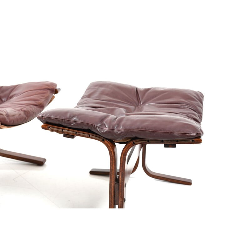 Pair of burgundy lounge chairs by Ingmar Relling