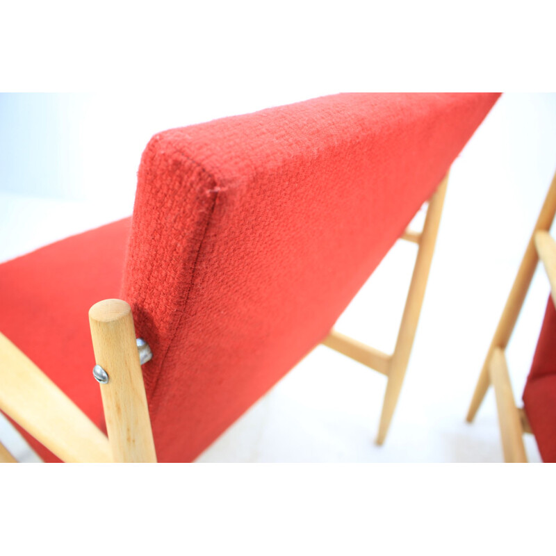 Pair of vintage armchairs in red fabric and oak, Czech 1960