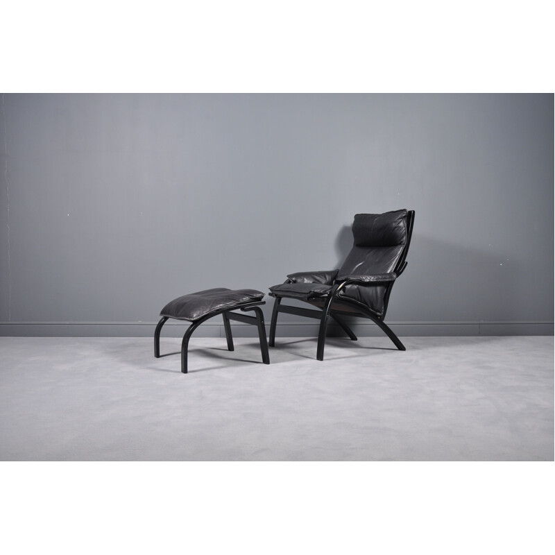 Vintage danish reclining armchair and ottoman in black leather 1960