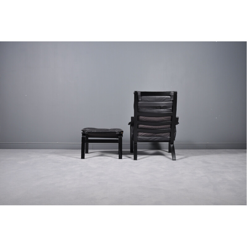 Vintage danish reclining armchair and ottoman in black leather 1960