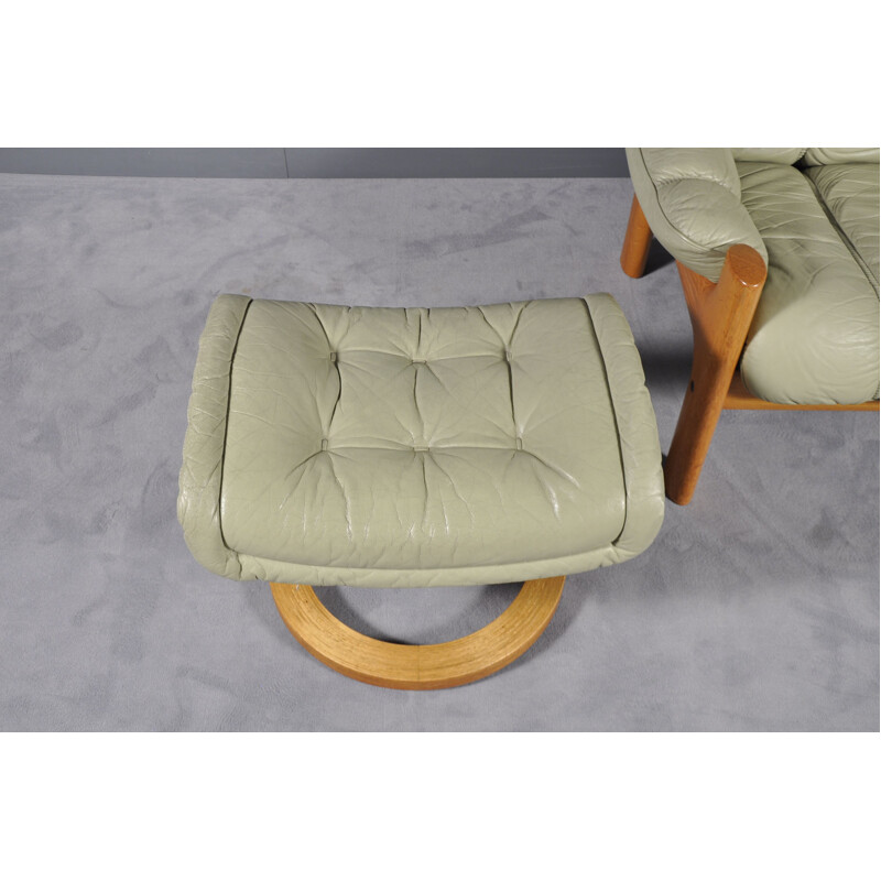 Vintage Montana green leather armchair with its footrest 1970