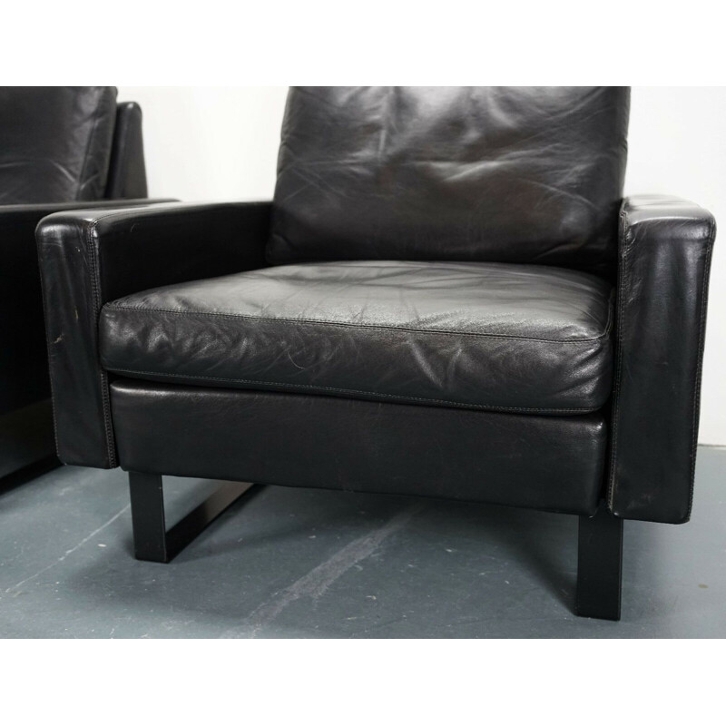 Pair of Conseta armchairs in black leather