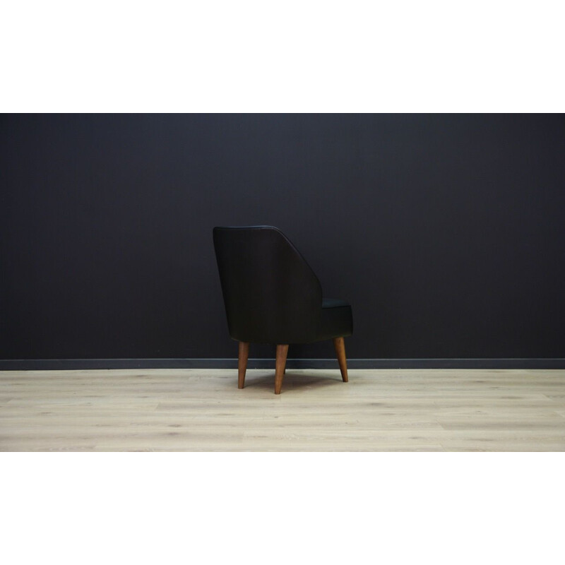 Vintage wooden armchair in black leather