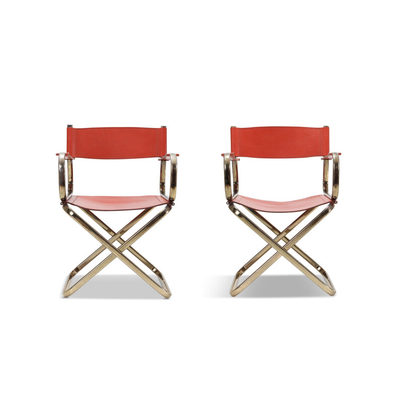 Pair of brass and red leather chairs