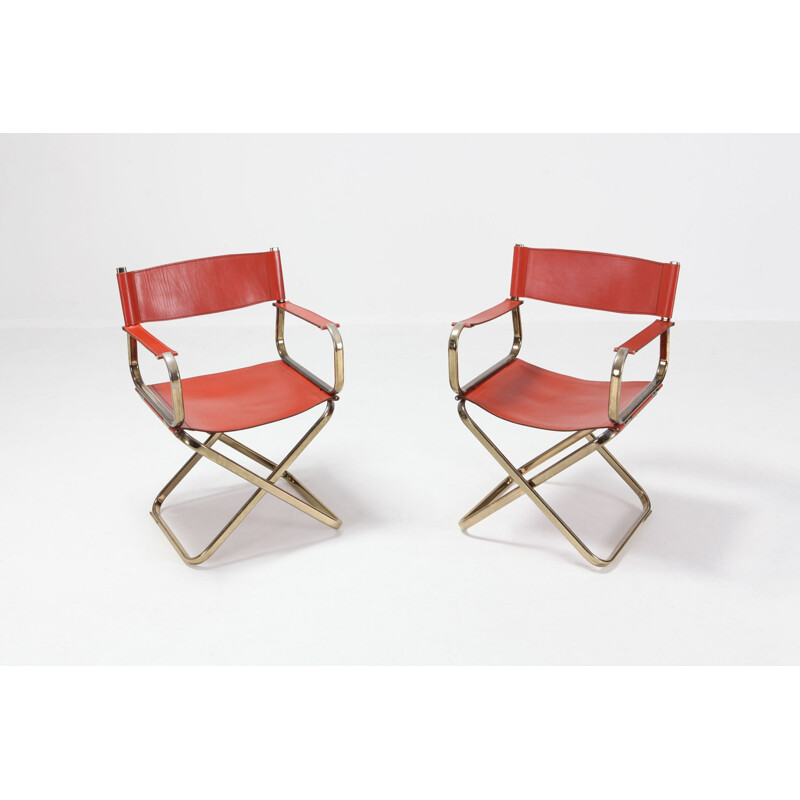Pair of brass and red leather chairs
