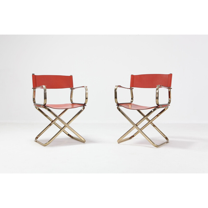 Pair of brass and red leather chairs