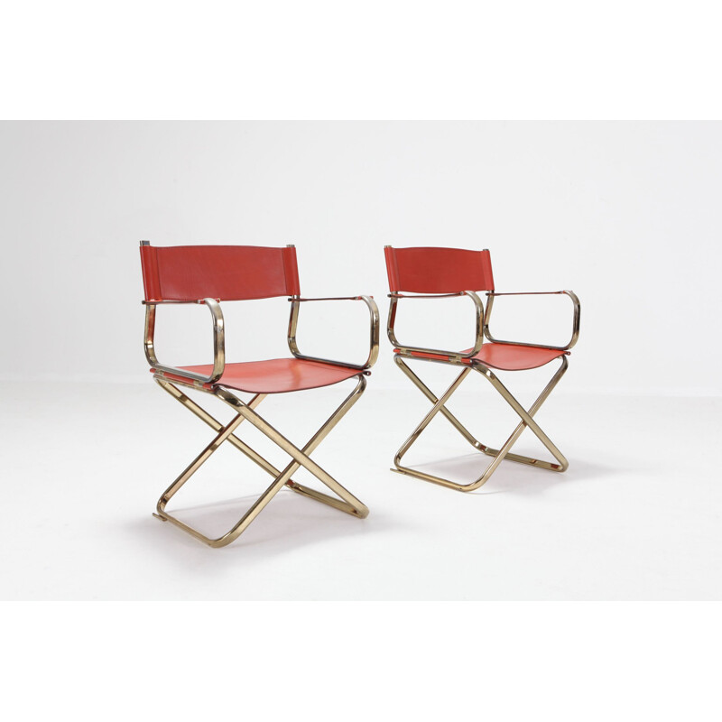 Pair of brass and red leather chairs