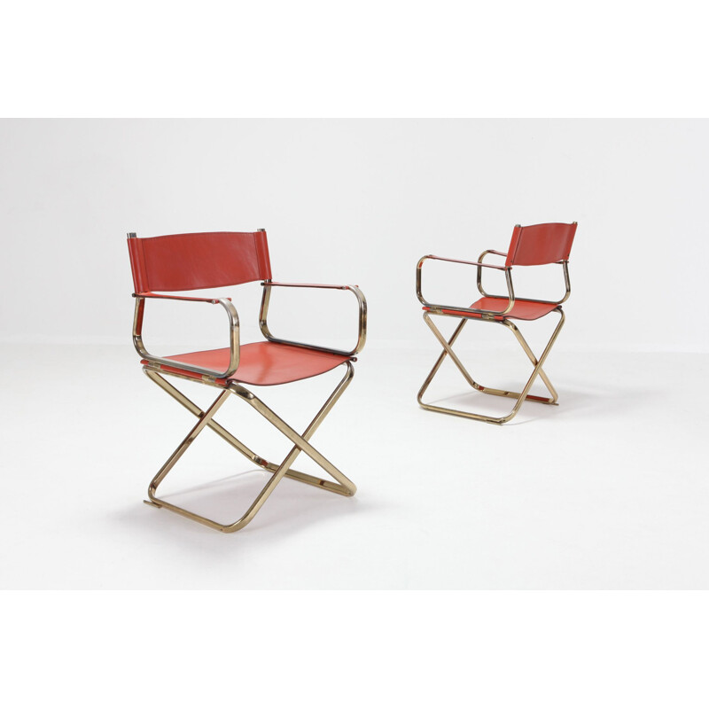 Pair of brass and red leather chairs