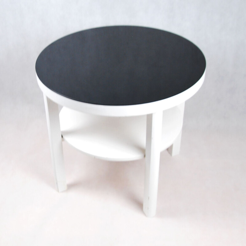 White coffee table with black glass top