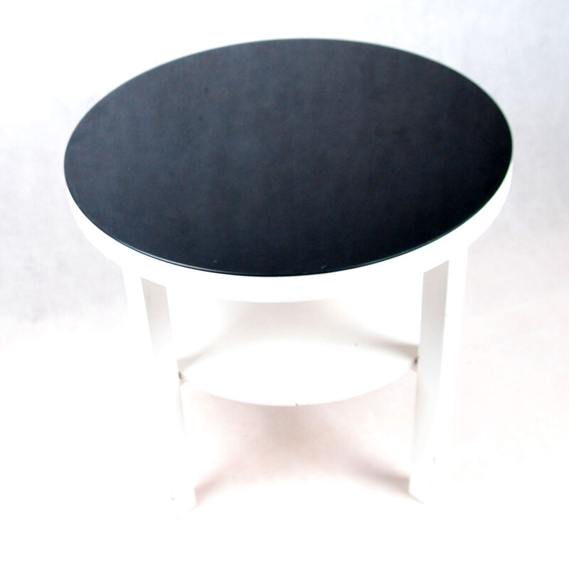 White coffee table with black glass top