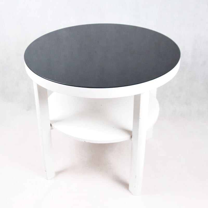 White coffee table with black glass top