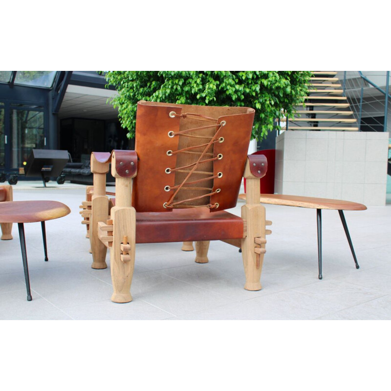 Pair of armchairs and ottomans in tawny leather laced 1960 s