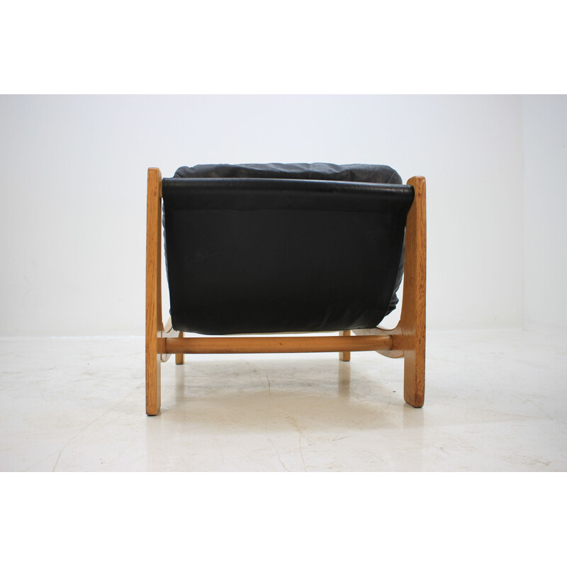 Pair of vintage scandinavian armchairs in black leather and wood 1970
