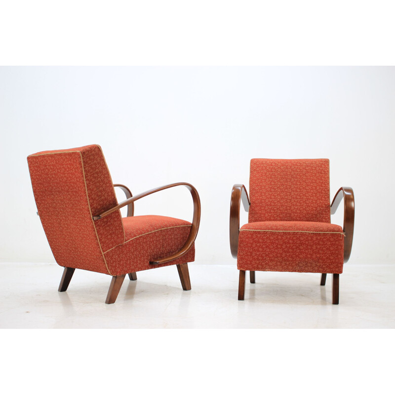 Pair of red armchairs by Jindřich Halabala