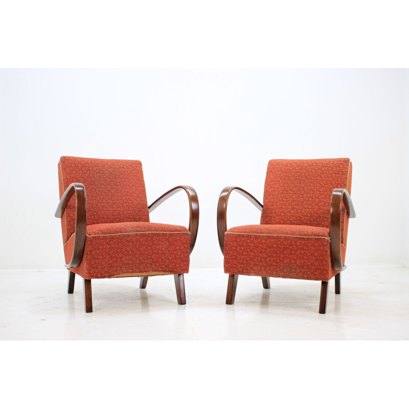 Pair of red armchairs by Jindřich Halabala