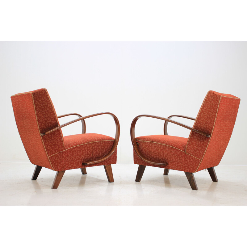 Pair of red armchairs by Jindřich Halabala