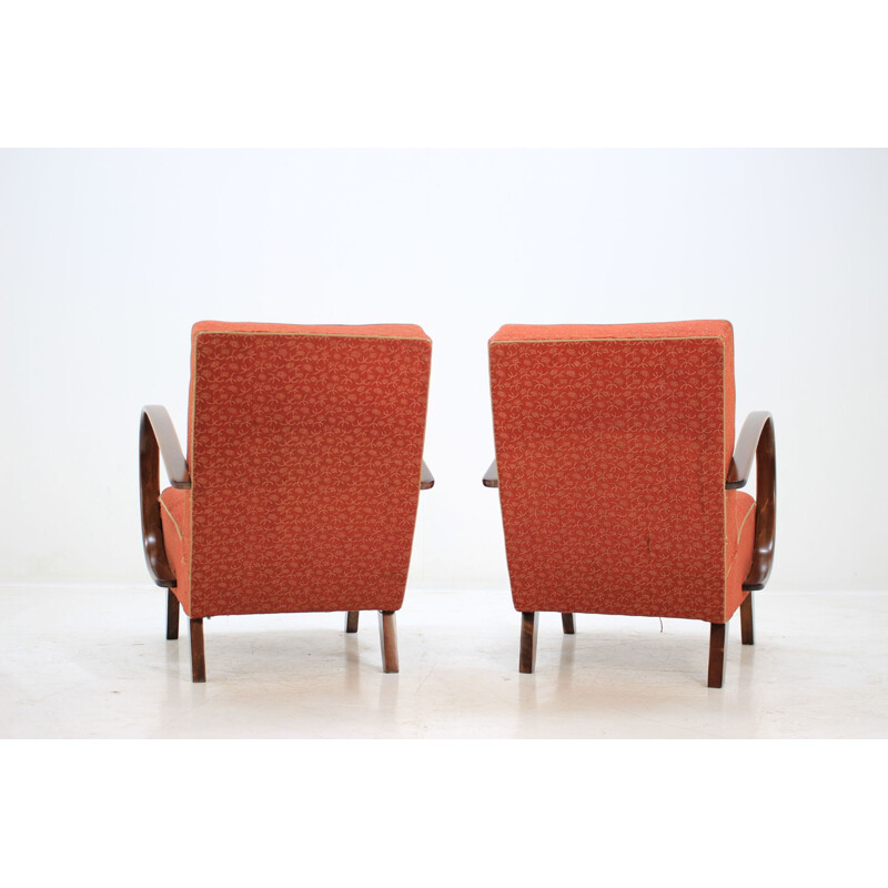 Pair of red armchairs by Jindřich Halabala