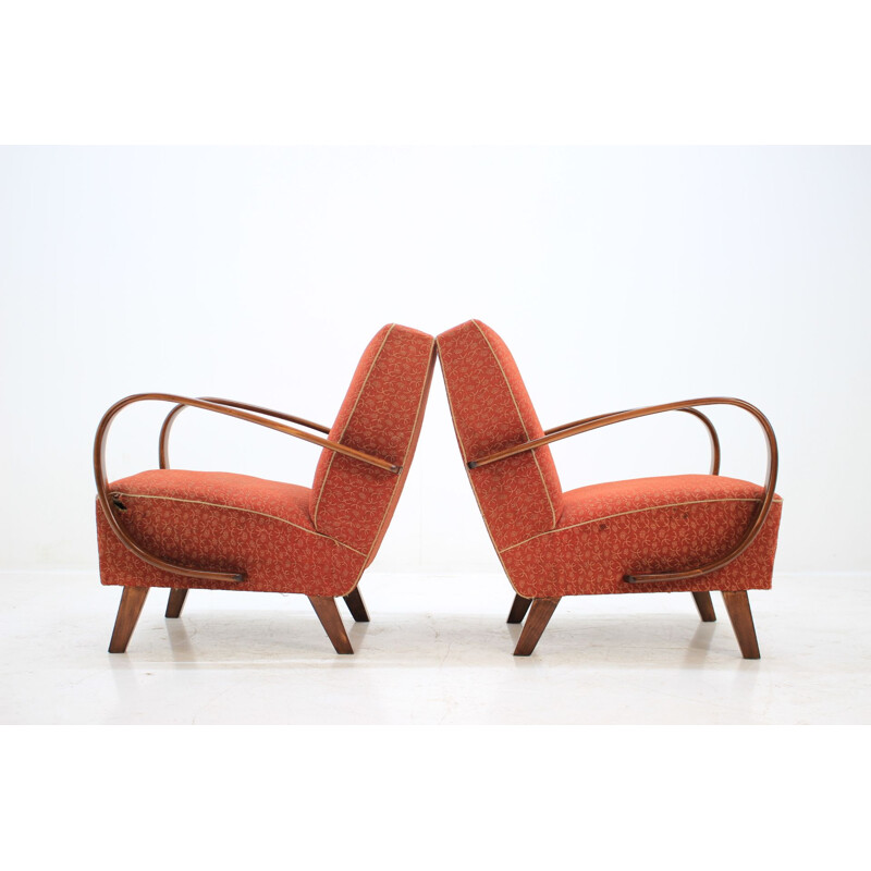 Pair of red armchairs by Jindřich Halabala