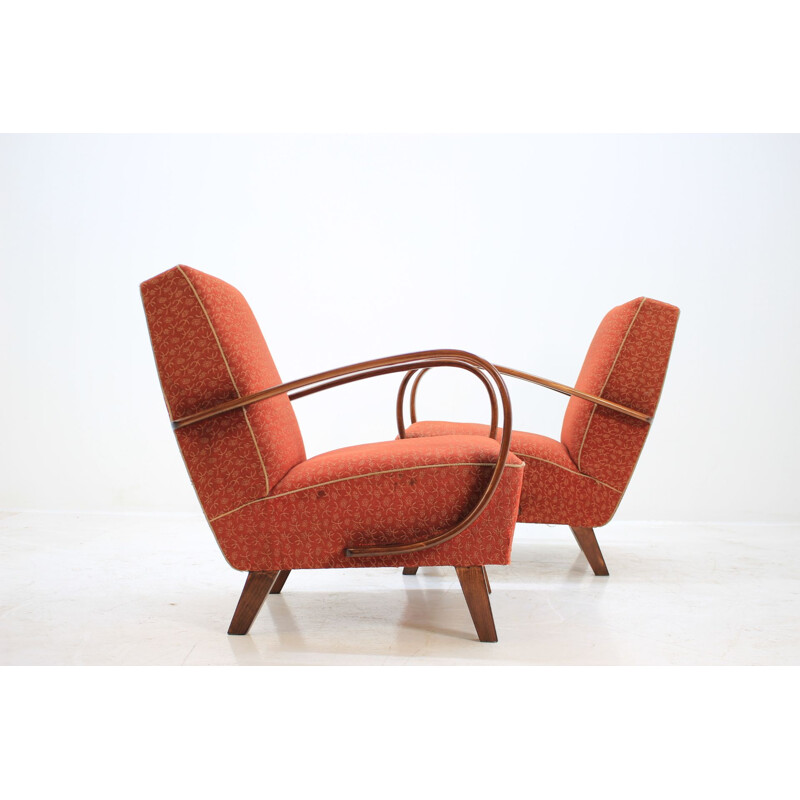 Pair of red armchairs by Jindřich Halabala