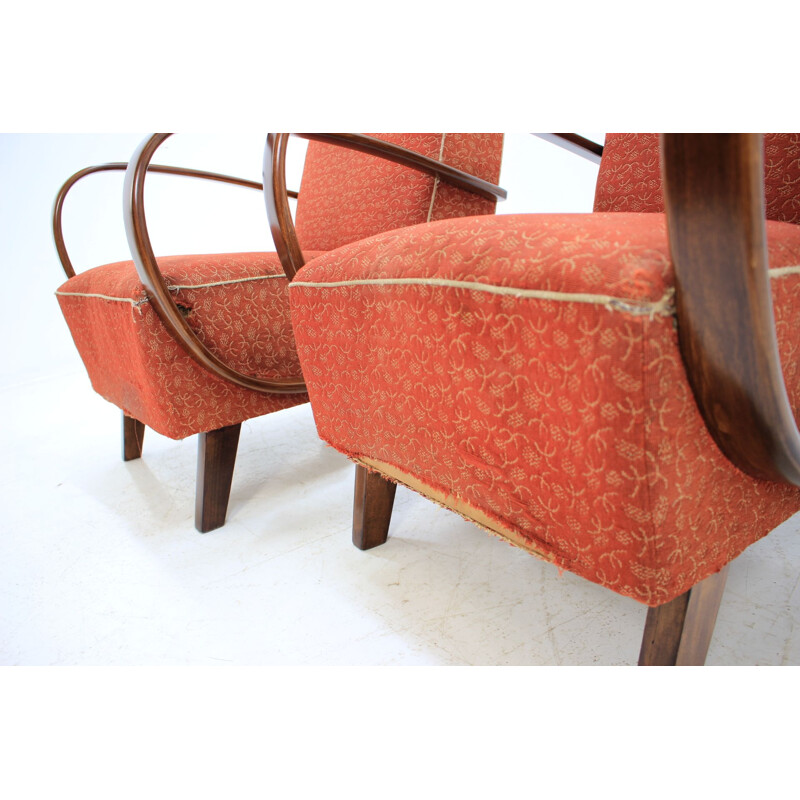 Pair of red armchairs by Jindřich Halabala