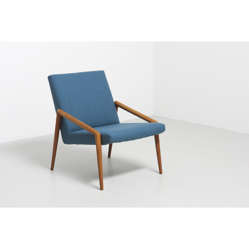 Vintage easy chair with rond teak armrest in blue wool fabric