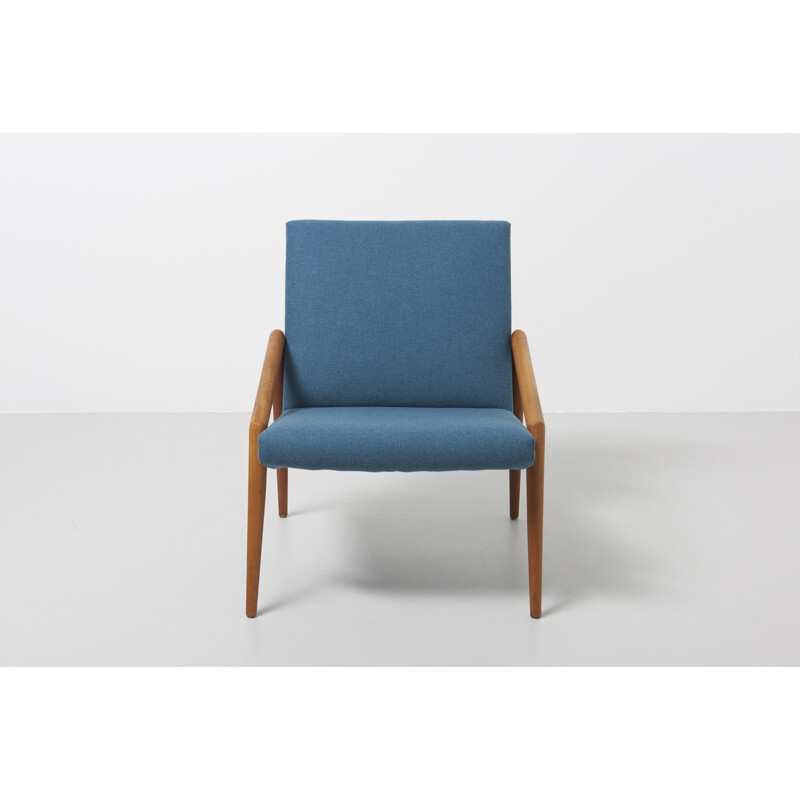 Vintage easy chair with rond teak armrest in blue wool fabric