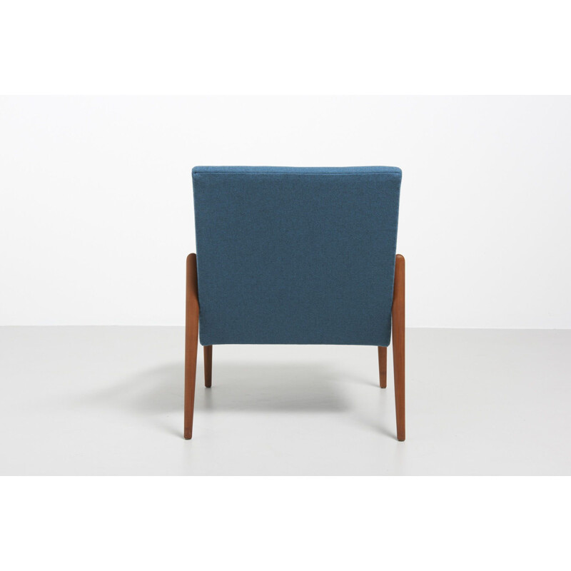 Vintage easy chair with rond teak armrest in blue wool fabric