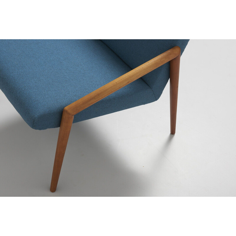 Vintage easy chair with rond teak armrest in blue wool fabric