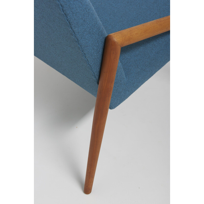 Vintage easy chair with rond teak armrest in blue wool fabric