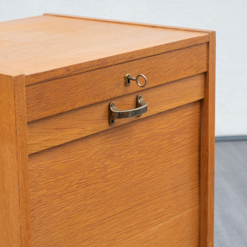 Vintage roller shutter cabinet in oak from the 50s