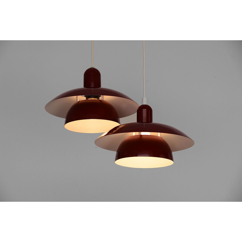 Pair of red pendant lamps by Hamalux