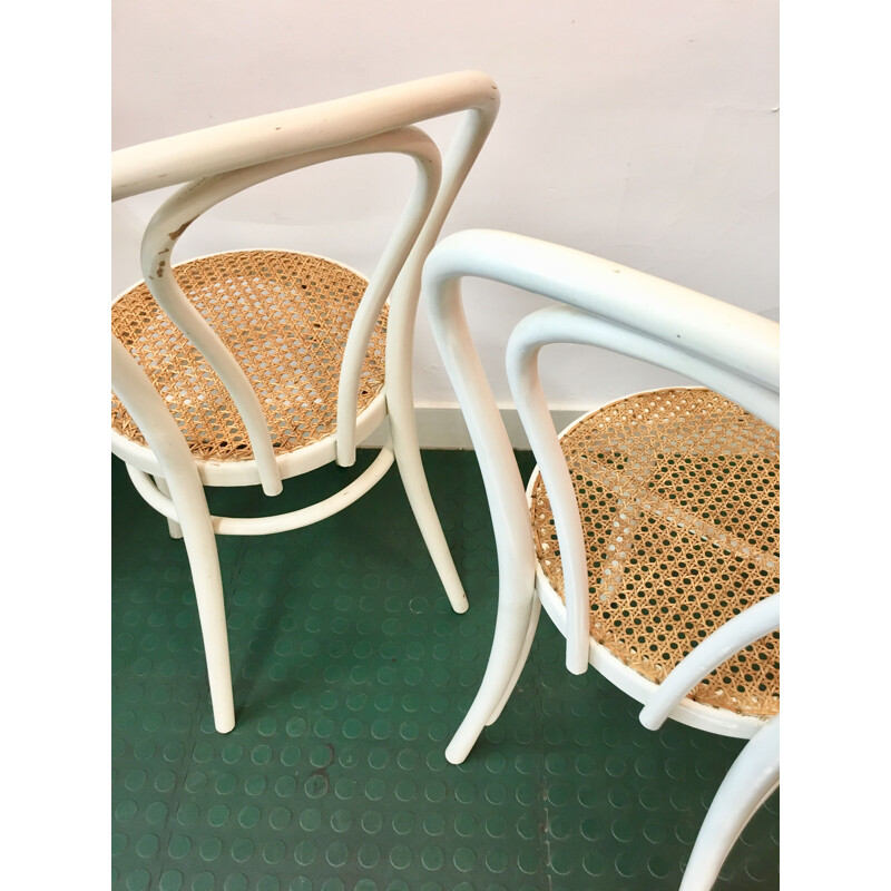 Pair of white bistro chairs with rattan seating