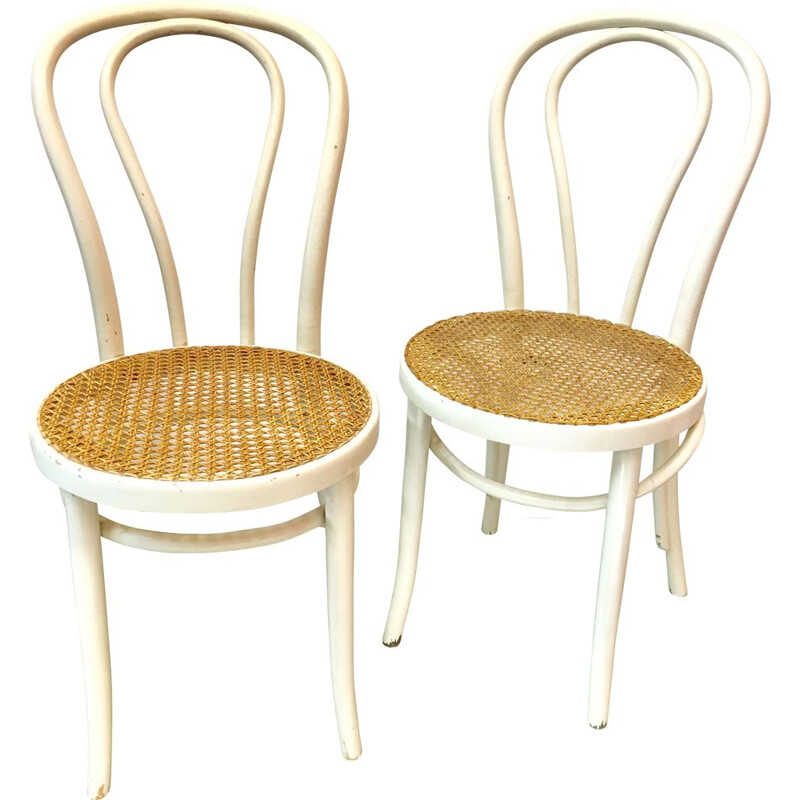 Pair of white bistro chairs with rattan seating