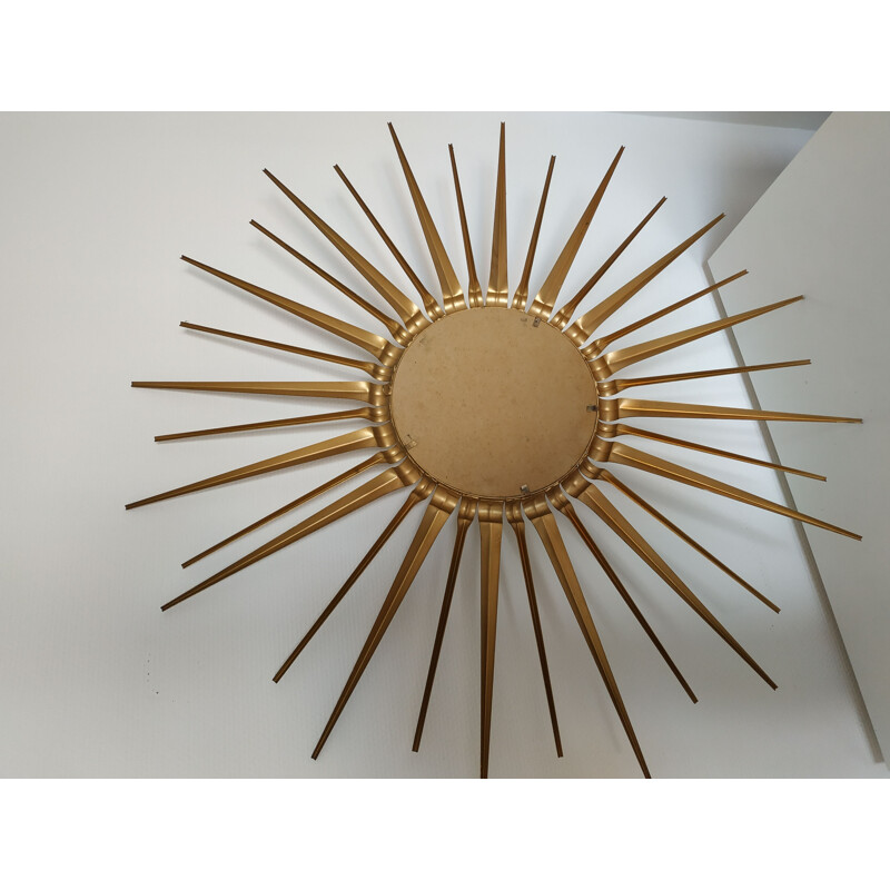 Vintage sun mirror golden metal bulging