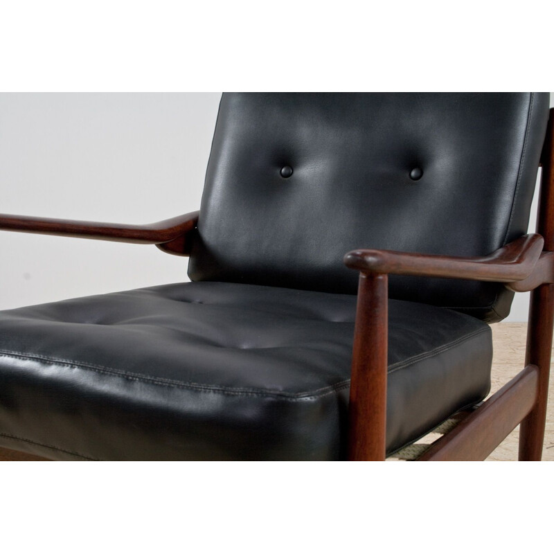 Pair of rosewood and black leatherette armchairs by Grete Jalk